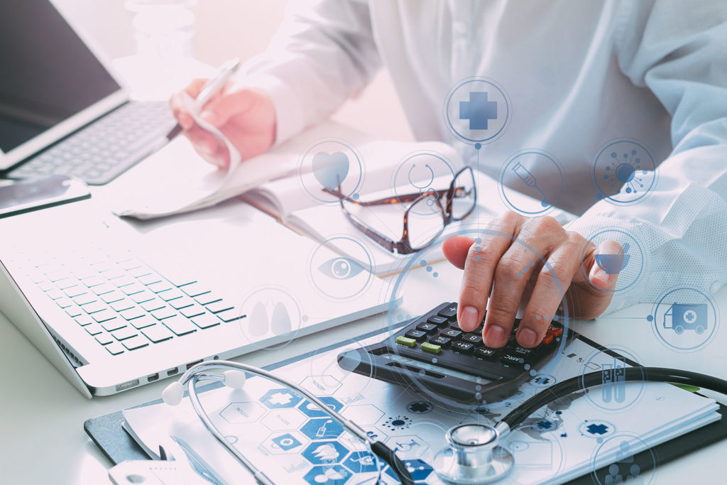 doctor using calculator to determine benefits of working with a medical funding source